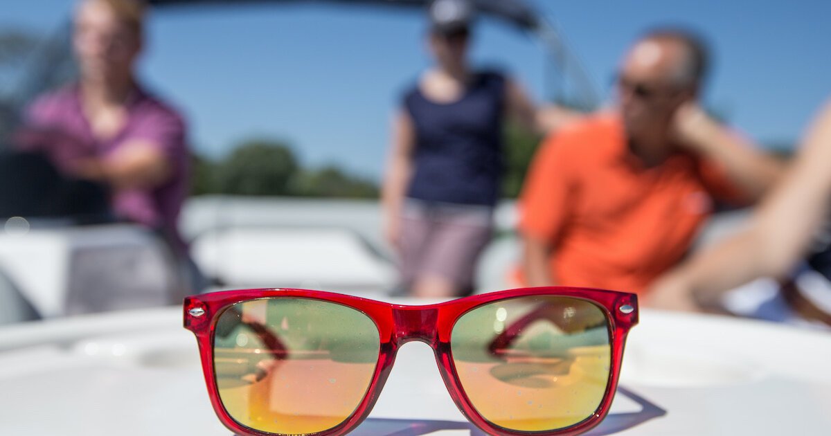 an iguana wearing sunglasses on a boat. the boat is a | Stable Diffusion